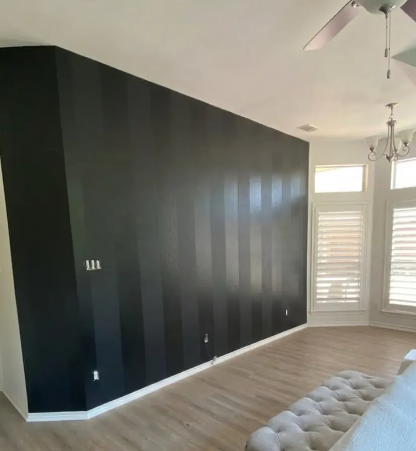 Living room with a bold black striped accent wall in a McKinney, TX home