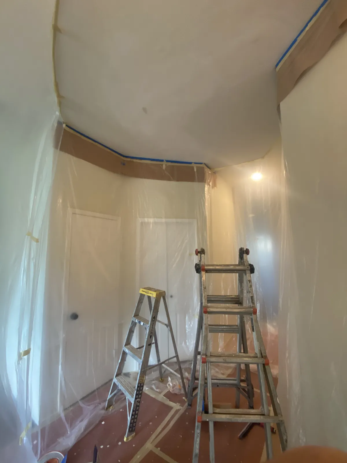 Room fully masked with plastic during a drywall ceiling repair in McKinney, TX