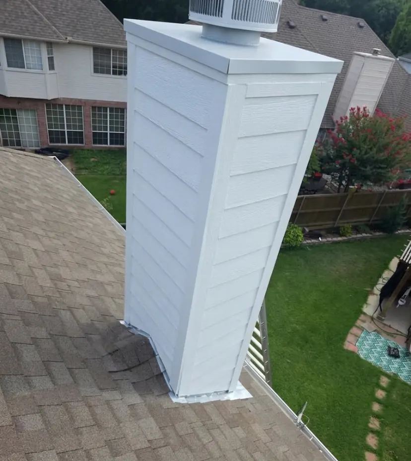 Freshly painted white chimney shroud on a rooftop in McKinney, TX