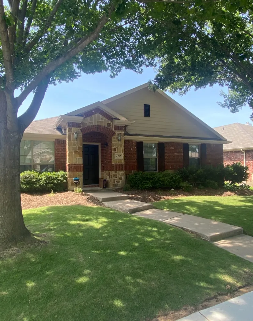 Brick and stone home with freshly painted trim and shutters in McKinney, TX