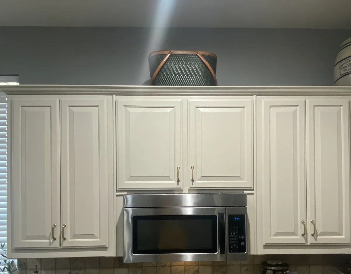 Freshly painted cabinet doors with new brass hardware in a McKinney, TX kitchen