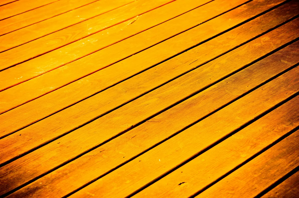 Close-up of stained deck boards showing rich color and protected wood grain